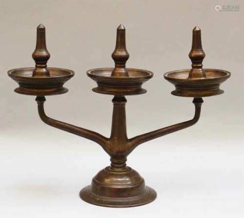 Asian Bronze Candelabra. A round base with three branches and three tazzas with candle-peaks
