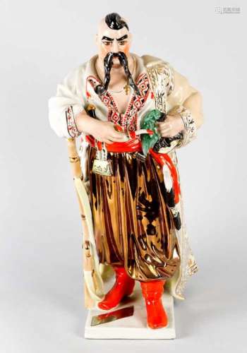 Russian Porcelain Figure, of a bojar with pipe and riffle on geometrical base, gilded and painted,