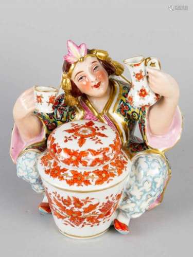 Russian Porcelain Figure, a sitting lady in traditional dress with jacket and cap, in the centre a