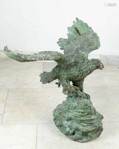 Monumental bronze eagle with stretched wings on naturalistic base, greenish brown patina, bronze