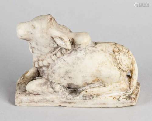 Indian Sculpture, of a lying cow, marble, on rectangular base, parts missing and damages, 18th/