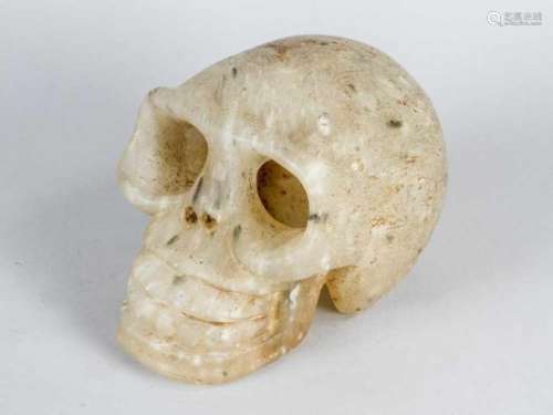 Jade Skull, naturalistic sculpted, white jade with black and brown inclusions, signs of age.15 x