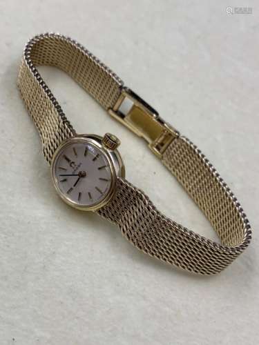 A LADIES 9ct GOLD OMEGA BRACELET WATCH WITH A LADDER CLASP COMPLETE WITH REPAIR WARRANTY CARD