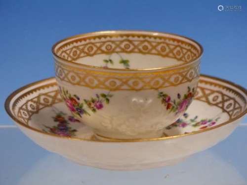 AN 18TH CENTURY TEA BOWL AND SAUCER, POSSIBLY DOCCIA, MOULDED IN RELIEF WITH CHERRY BLOSSOM SPRIGS