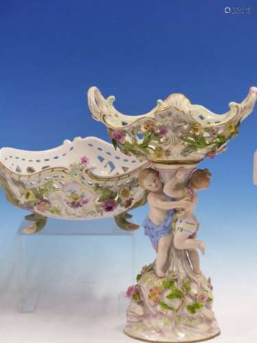 TWO MEISSEN TWO HANDLED BASKETS, ONE SUPPORTED BY TWO CHILDREN STANDING ON A ROCKY PLINTH. H