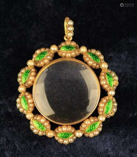 A Pretty Rock Crystal Locket framed in a 15 carat gold surround set with navettes of green enamel