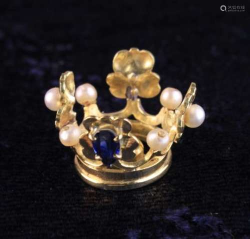 A Miniature Gold Crown set with small pearls and an inverted tear drop sapphire.