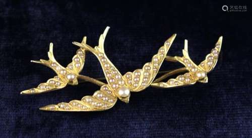 A Victorian 15 Carat Gold & Seed Pearl Brooch in the form of three swallows.