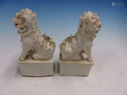 A PAIR OF BLANC DE CHINESE SEATED BUDDHIST LION JOSS STICK HOLDERS. H 13.5cms.