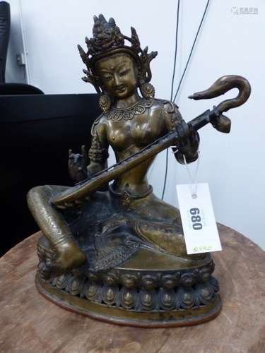 A TIBETAN BRONZE FIGURE OF SARASWATI, THE MUSIC GODDESS SEATED ON A DOUBLE LOTUS THRONE PLAYING A