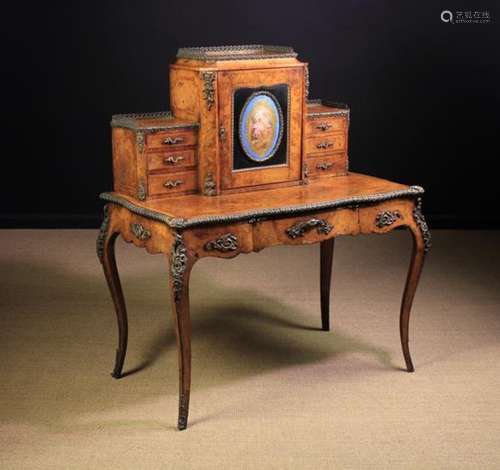 A 19th Century Figured Walnut Bonheur du Jour with diagonally grained tulipwood borders edged with