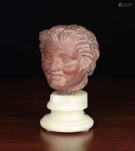 A Carved 'Rosso Antico' Marble Head of a Satyr with Hellenistic influences,