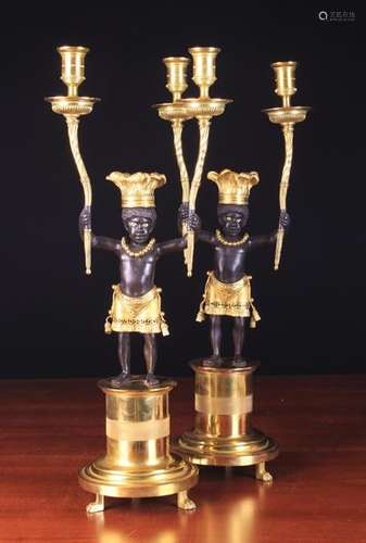 A Pair of Empire Style Bronze & Gilt Bronze Figural Candelabra.