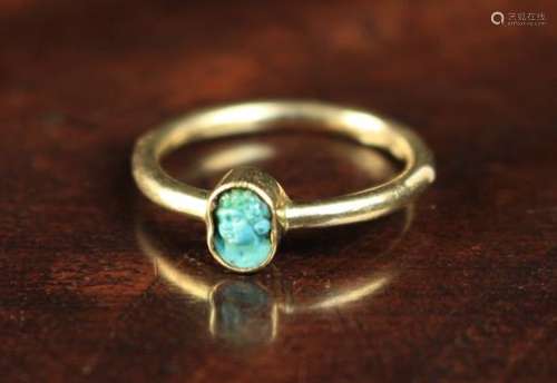 A Gold Ring inset with a small Roman turquoise cameo carved with a cherub's head.