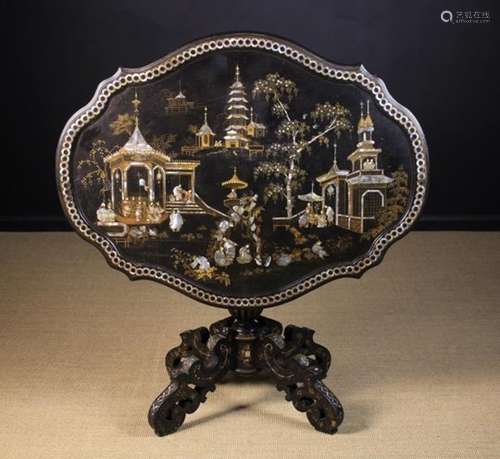 A Victorian Black Lacquered Tilt Top Table elaborately decorated with mother-of-pearl inlay and