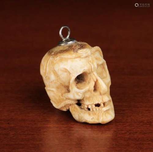 A 17th Century German Carved Bone Momento Mori 'Transi' carved and half man/half skeleton,