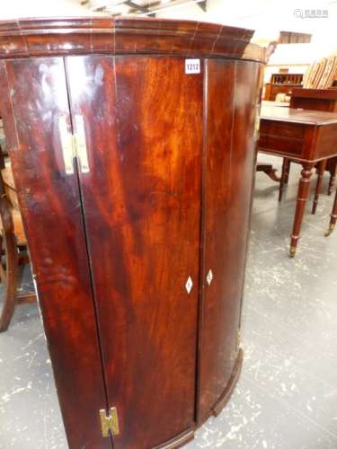 A GEO.III.MAHOGANY BOW FRONT TWO DOOR WALL HANGING CORNER CABINET. W.72 x H.102cms.