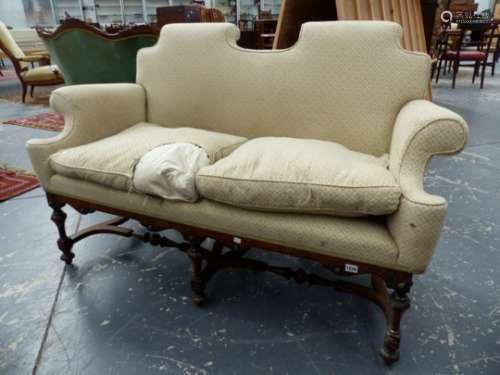 AN EARLY 20th.C.WALNUT FRAMED CAROLEAN STYLE TWO SEAT SETTEE WITH OVER SCROLL ARMS AND TURNED LEGS