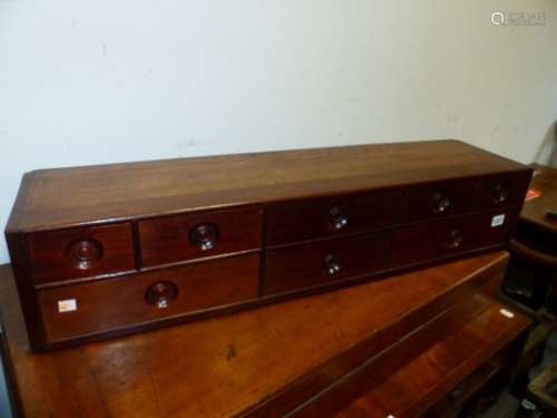 A MAHOGANY SMALL NEST OF SEVEN DRAWERS WITH RECESSED HANDLES. 92 x 22 x 19cms.