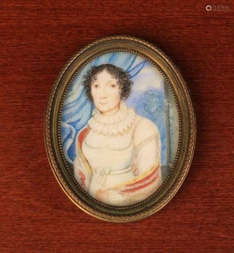 An Early 19th Century Oval Miniature: Half length portrait of a lady, set in a brass frame,