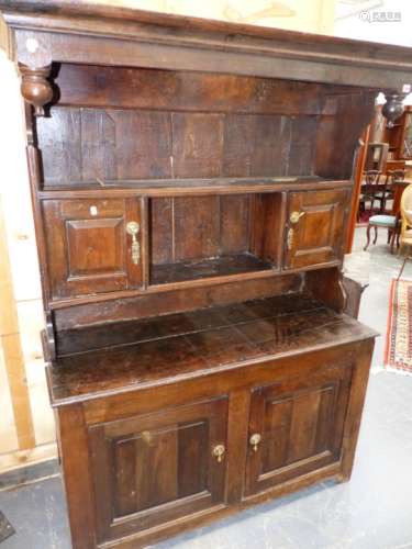 A 17th/18th.C.WELSH OAK CANOPY TOP DRESSER, DEEP SHELVES TO RACK WITH TWO SMALL PANEL DOOR