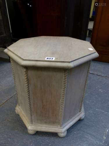 A LIMED OAK OCTAGONAL LIFT TOP COAL BOX ON BUN FEET. W.42 x H.41cms.