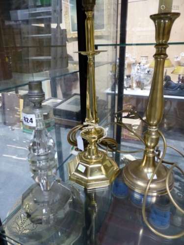 TWO BRASS CANDLESTICK TABLE LAMPS, THE TALLER WITH OCTAGONAL FOOT. H 42cms. TOGETHER WITH A GLASS
