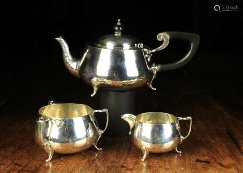 An Art Deco Hammered Silver Three Part Teaset with assay marks for Birmingham 1930.