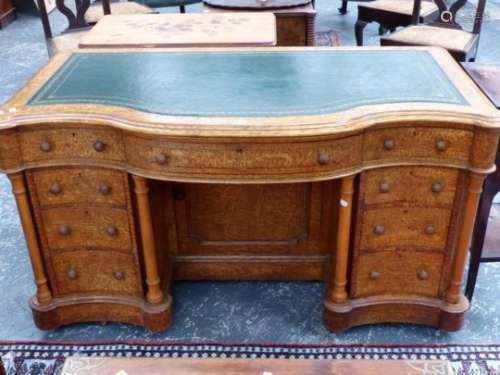 A HUNGARIAN ASH LARGE KNEEHOLE WRITING DESK WITH SERPENTINE TOP OVER CENTRAL RECESSED CUPBOARD