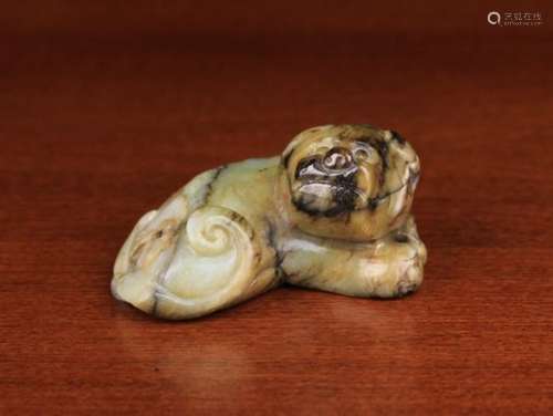 A Ming Period Jade Carving of Reclining Dog with scrolled tail, 2¼