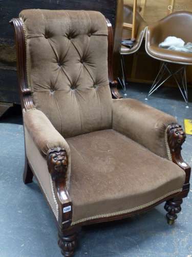 A VICTORIAN LIBRARY ARMCHAIR WITH MAHOGANY SHOW FRAME AND CARVED LION MASK ARM SUPPORTS.