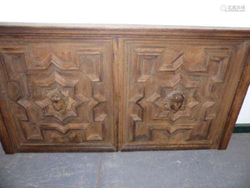 A LARGE 19th.C.DOUBLE OAK PANEL WITH CENTRAL CARVED MASKS AND GEOMETRIC MOULDINGS. 142 x 75cms.