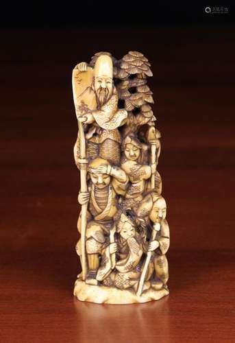 A 19th Century Carved Walrus Tusk Okimono depicting The Seven Gods of Luck & Good Fortune climbing