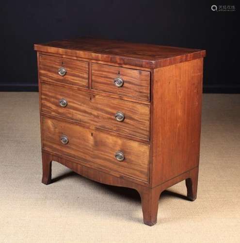 A Late Georgian Mahogany Chest of Drawers. The rectangular top inlaid with ebony stringing.