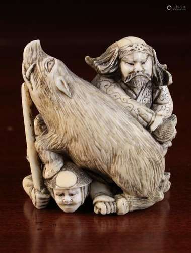 A 19th Century Signed Japanese Ivory Okimono carved swith a wild boar & two figures, signed on base,