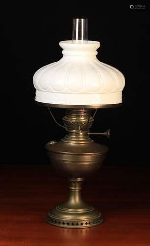 A Brass Oil Lamp with glass chimney and moulded white glass shade, 23