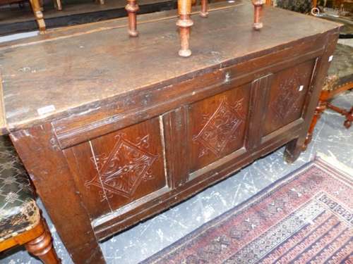 AN 18th.C.AND LATER OAK COFFER, CARVED PANEL FRONT WITH ASSOCIATED PLANK TOP. 115 x 55 x H.68cms.