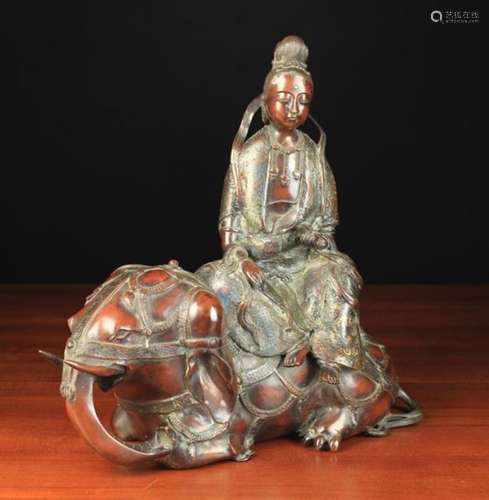 A Fine Reddish Brown Patinated Bronze Guanyin Samantabhadra sat upon a recumbent Elephant.