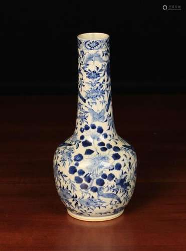 A Chinese Blue & White Bottle Vase decorated with birds and butterflies amongst flowering foliage