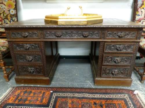 A VICTORIAN CARVED OAK TWIN PEDESTAL WRITING DESK WITH ARRANGEMENT OF NINE DRAWERS. 152 x 84 x H.