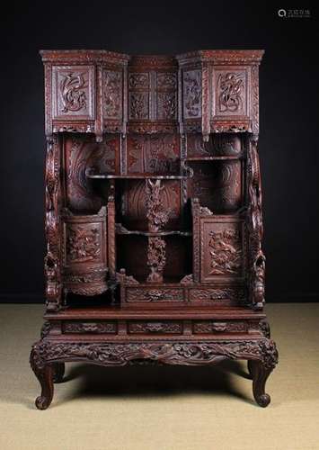 A Large Early 20th Century Japanese Lacquered Cabinet on Stand elaborately carved with flowers,