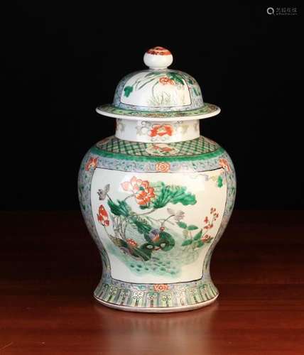 A Famille Verte Baluster Vase & Cover decorated with ducks amongst flowering lotus to one side and