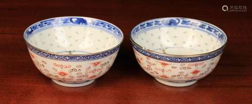 A Pair of Chinese Rice Bowls decorated with underglaze blue floral sprays to centre panels,