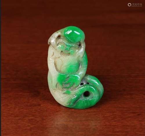 An Oriental Jade Pendant carved as a rén yú; the bearded figure with forked fish tail,