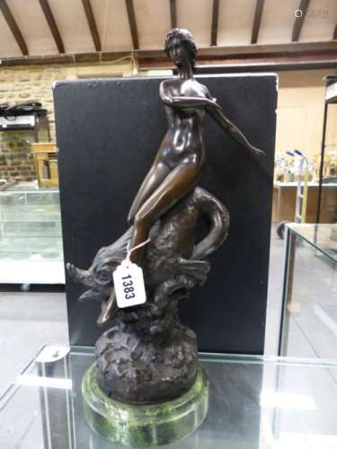 A BRONZE NUDE LADY RIDING A DOLPHIN THROUGH WAVES, BEARS SIGNATURE F PREISS, GREEN MARBLE PLINTH.