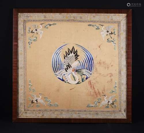 An Antique Chinese Silkwork Panel embroidered with a central roundel design of a crane and having