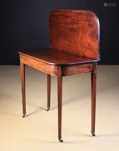 A George III Mahogany Tea Table inlaid with stringing.