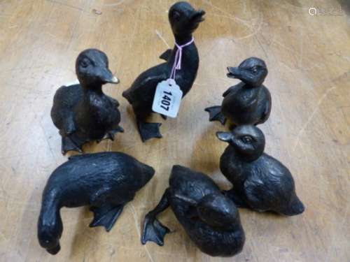 A SET OF SIX BRONZE DUCKLINGS DEPICTED IN A VARIETY OF POSES, THE METAL PATINATED BLACK, THE