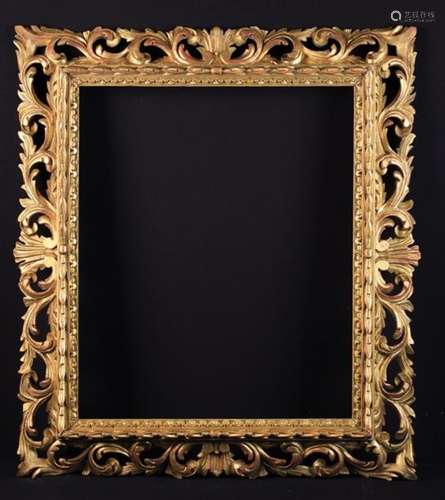 A Florentine Giltwood Frame open carved with undulating scrolls of acanthus;