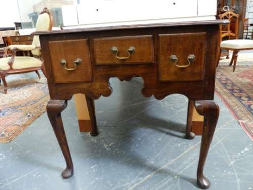 A GEO.III.STYLE OAK LOW BOY, THE TOP WITH RE-ENTRANT CORNERS OVER THREE SHORT DRAWERS, STANDING ON